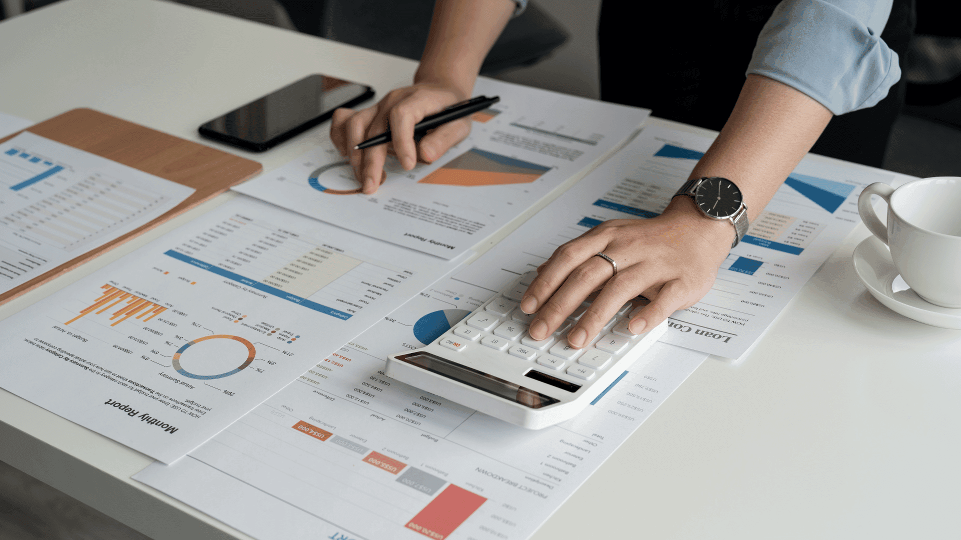 Person working on charts at a desk