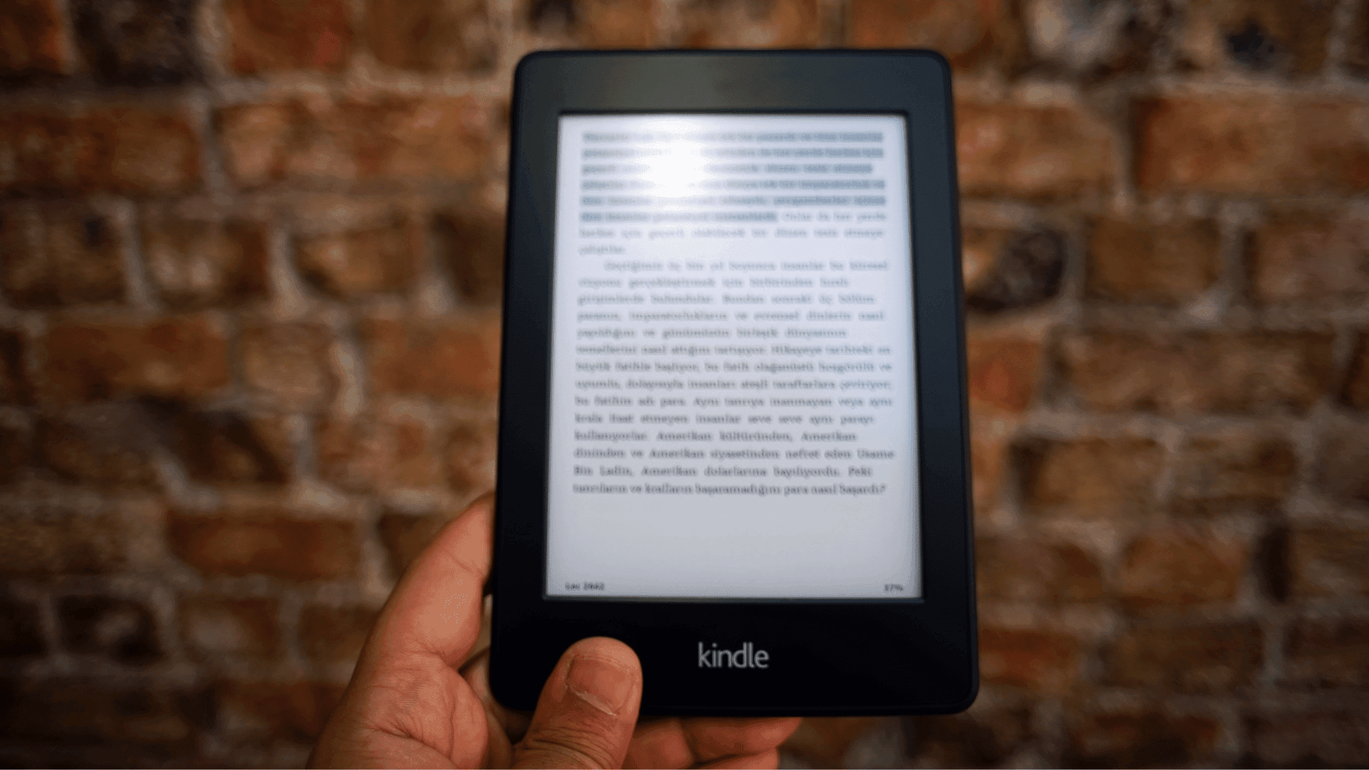 Man holding an Amazon Kindle