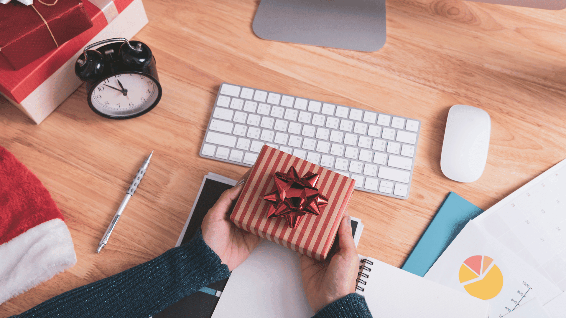 Person holding a gift box at their desk