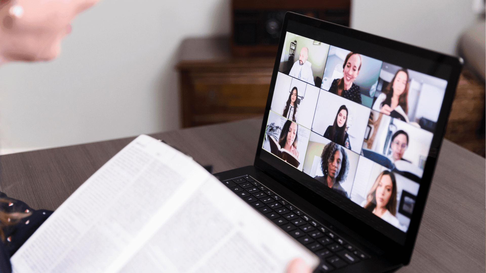 Woman attending an online book club meeting on a laptop