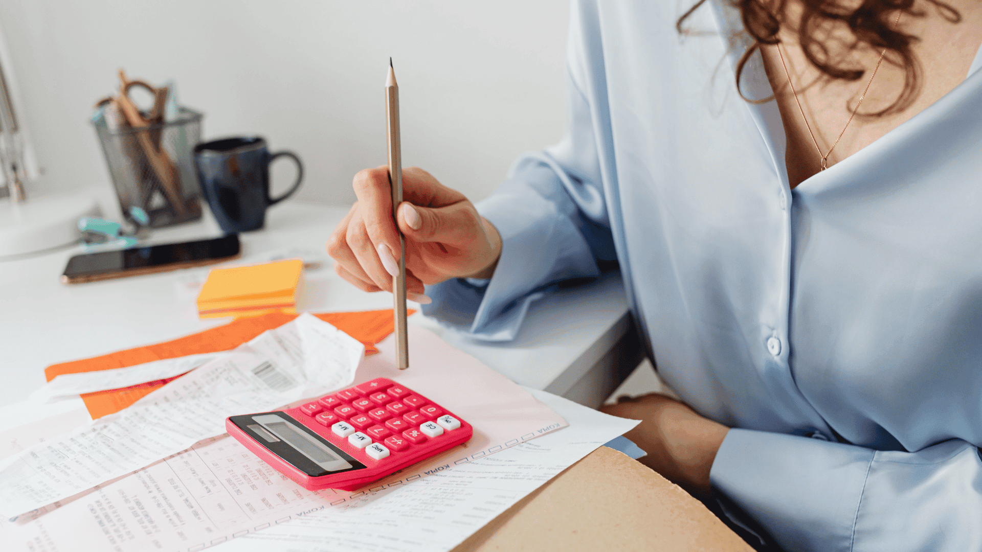Woman sitting at a desk working out a budget