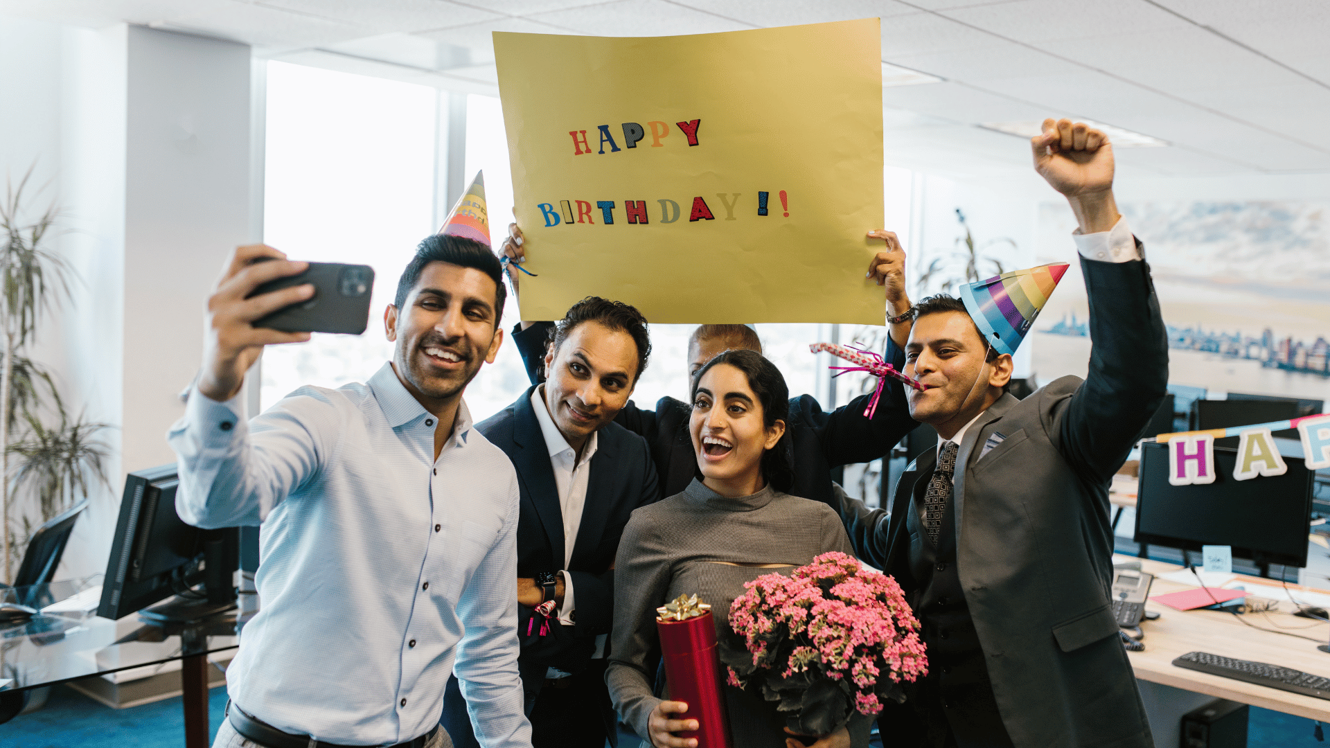 Employees in an office celebrating a birthday