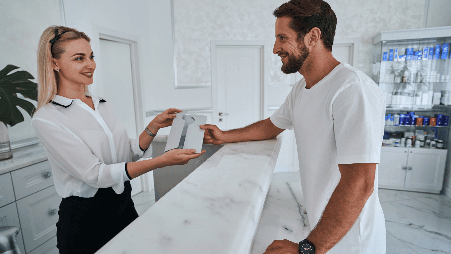 A man giving a gift to an employee in the office