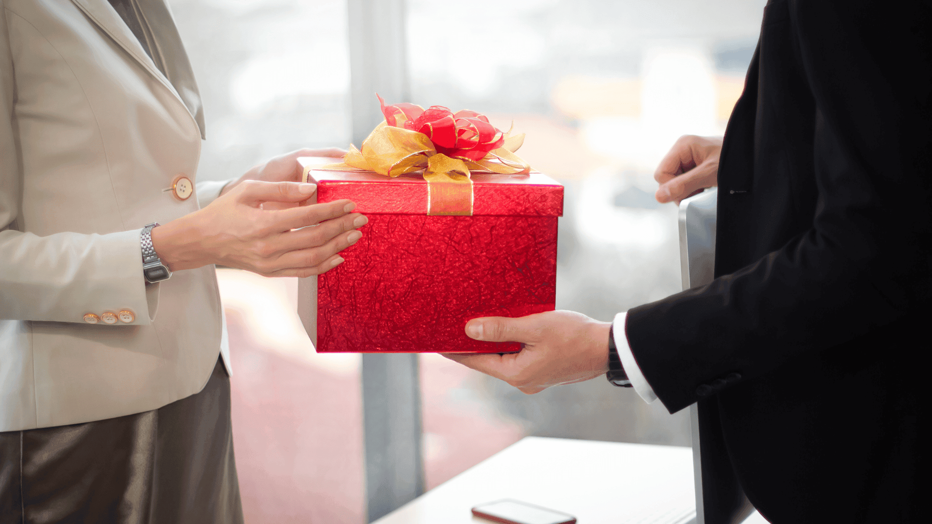 A manager giving a gift to an employee