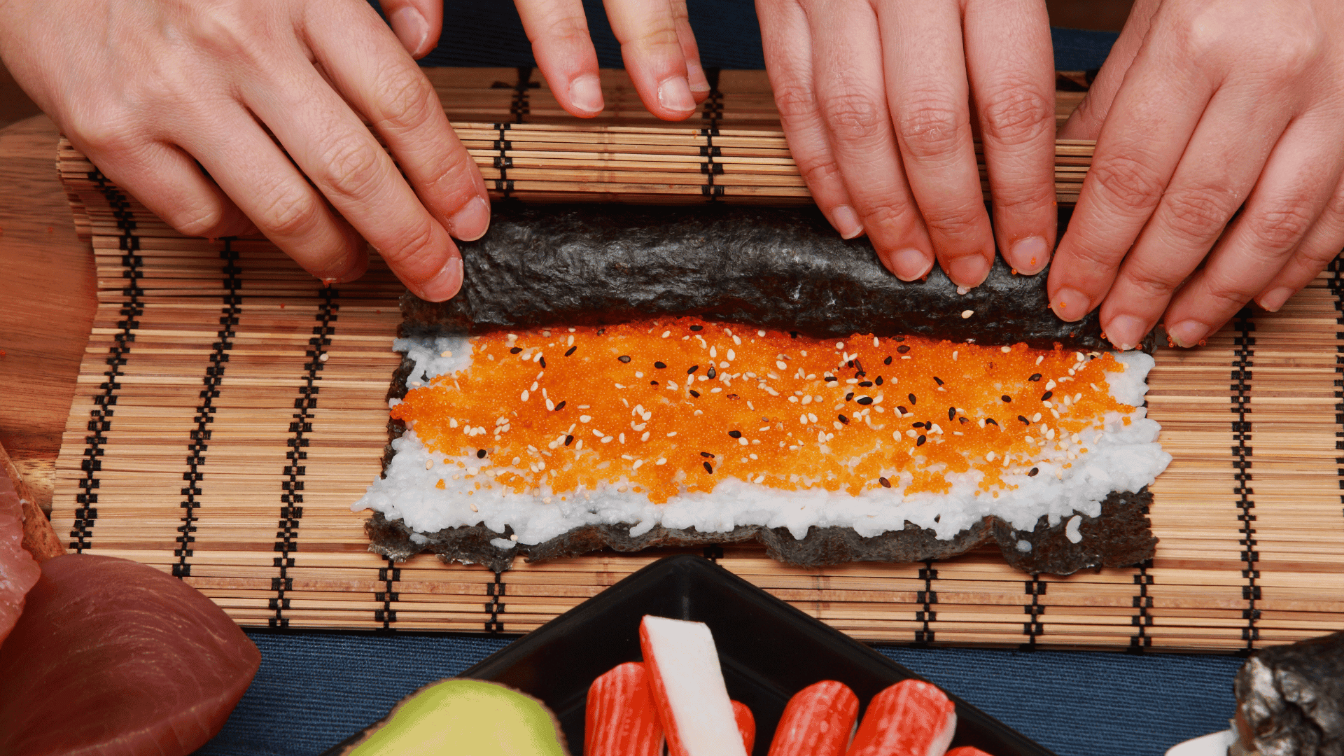 Two people rolling sushi